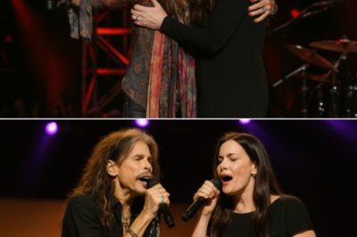 The crowd erupted in gasps before falling into awed silence when Steven Tyler, in the middle of his emotional set, paused, turned toward the wings of the stage, and called out, “Come sing with me, baby,” inviting his daughter Liv Tyler to join him for an unannounced duet that no one saw coming. As Liv walked out, visibly nervous yet glowing under the stage lights, the hall filled with cheers before the two began a stripped‑down, heart‑wrenching rendition of “I Don’t Want to Miss a Thing,” their voices — one weathered and iconic, the other soft and trembling — blending into a harmony that felt like a conversation between father and daughter in front of thousands. By the final chorus, Steven reached out and wrapped Liv in a tight embrace as they sang the last lines together, his voice breaking with emotion, and when the music faded, they stayed locked in that hug, crying, until the audience, overcome by the rawness of the moment, rose to their feet in a thunderous standing ovation. One fan later wrote, “It didn’t feel like a performance — it felt like witnessing love in its purest form.”